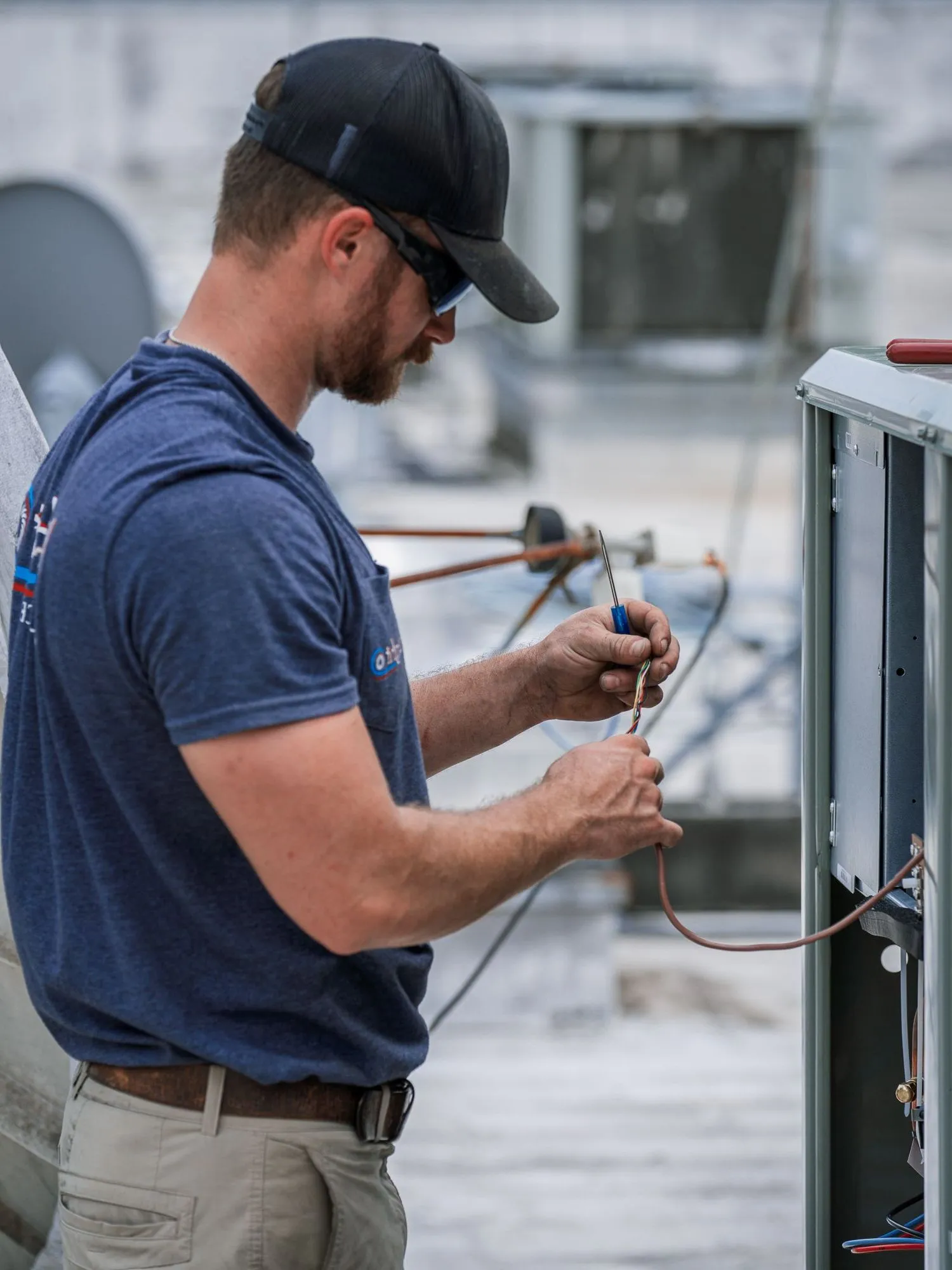Technician writing inspection notes during commercial HVAC repair evaluation