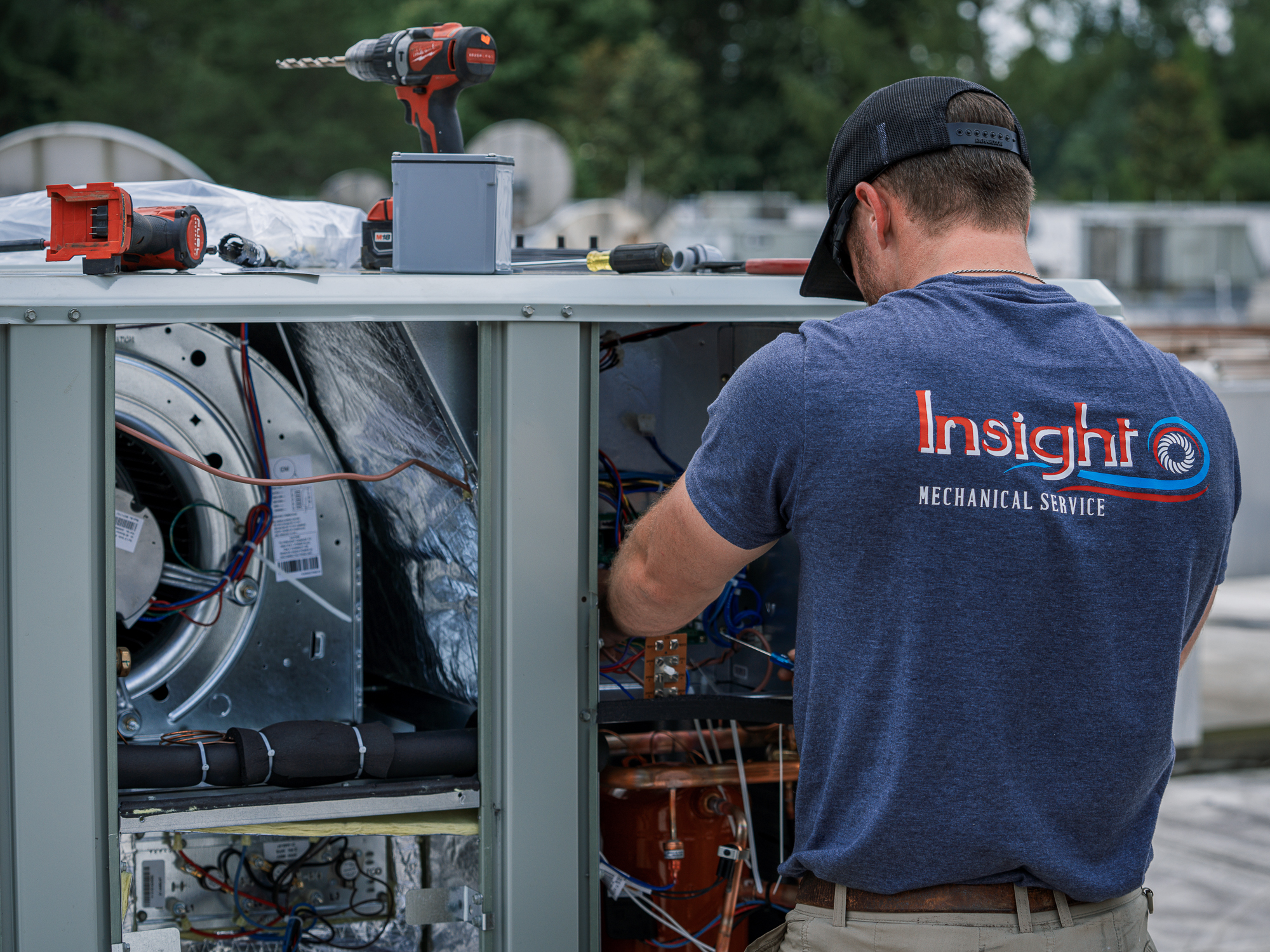 Insight Mechanical Services technician repairing rooftop HVAC equipment