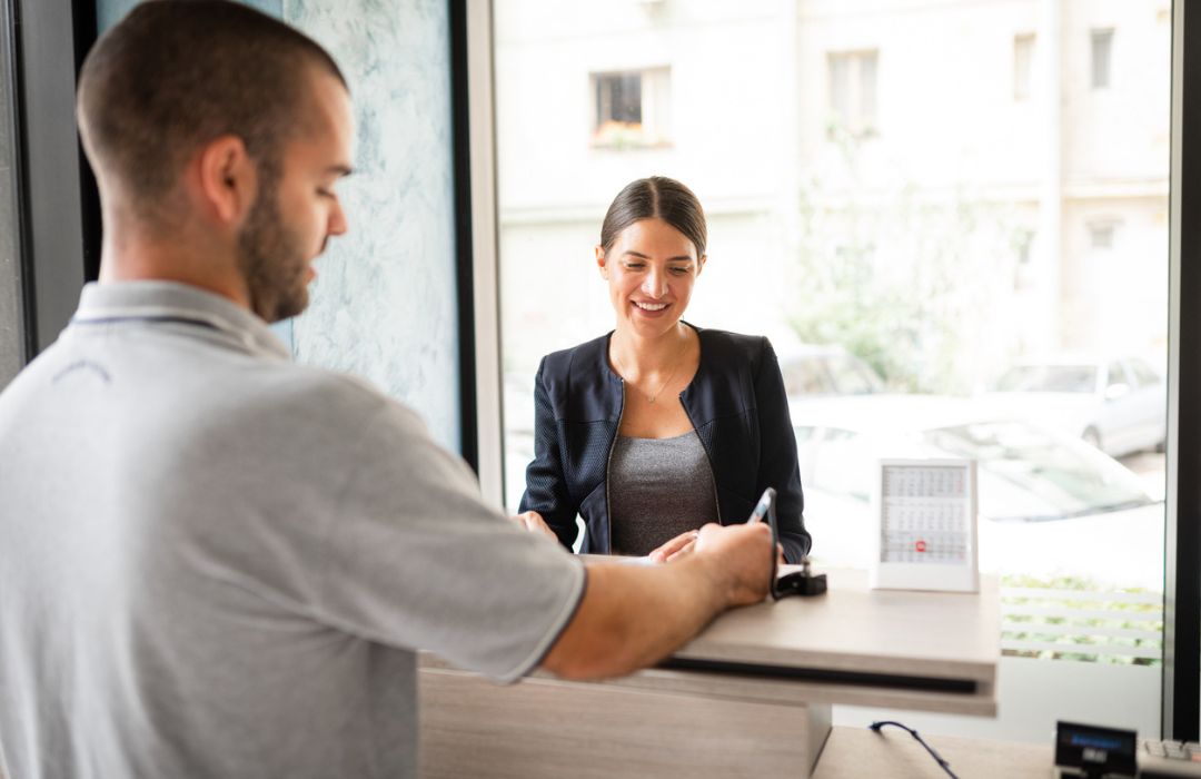 Customer checking in at a service desk during a commercial HVAC appointment