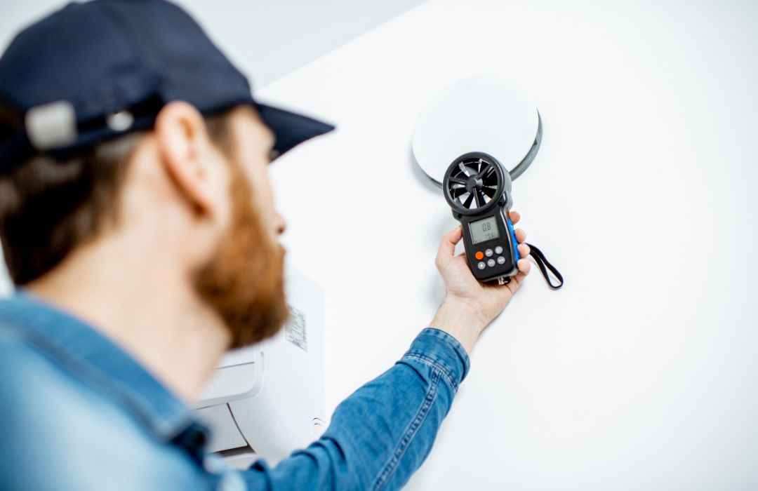 Technician checking refrigerant levels on a residential air conditioning unit during repair